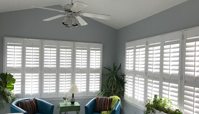 Southern California living room with fan and shutters